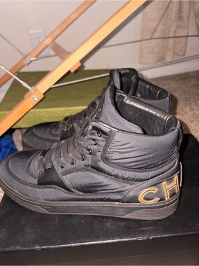 CHANEL Black High-Top Sneakers with Gold Heel Logo